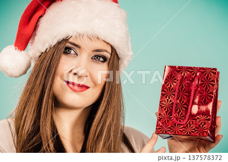 Happy Christmas woman holds red gift bag Happy Christmas woman holds red gift bag 137578372