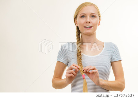 Blonde young woman with braid hair Blonde young woman with braid hair 137578537