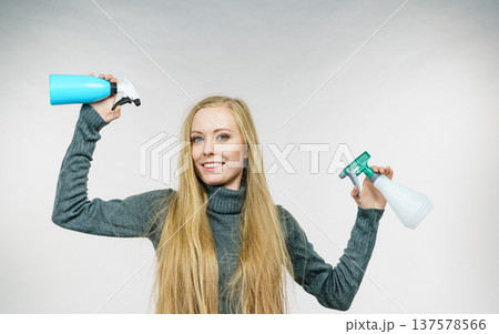 Female messy long hair holds spray bottle Female messy long hair holds spray bottle 137578566