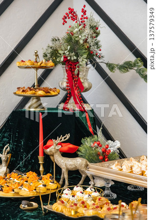 Christmas holiday buffet table with festive decorations Christmas holiday buffet table with festive decorations 137579349