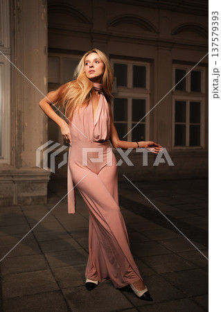 Elegant evening pose captured in a historic urban setting Elegant evening pose captured in a historic urban setting 137579393