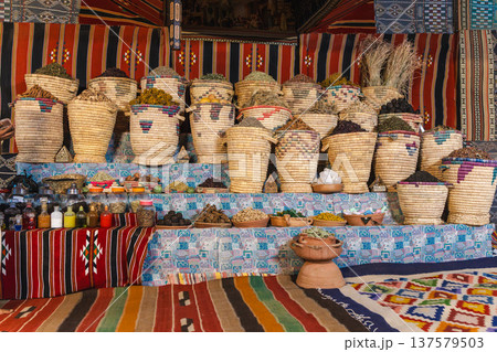 Traditional Egyptian market stall with herbal teas spices and medicinal herbs in woven baskets 137579503