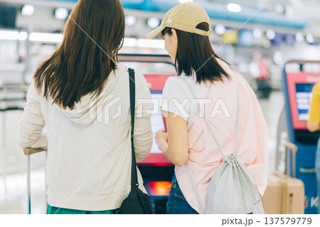 空港でセルフチェックインをする女性二人組　「撮影協力：関西国際空港（KIX）」 137579779