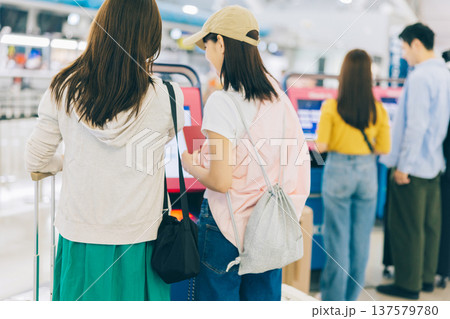 空港でセルフチェックインをする女性二人組 「撮影協力:関西国際空港(KIX)」 空港でセルフチェックインをする女性二人組 「撮影協力:関西国際空港(KIX)」 137579780