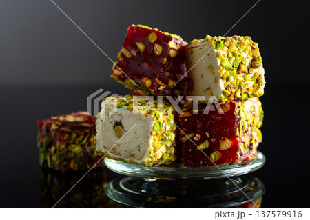 Turkish delights on a black reflective background. 137579916
