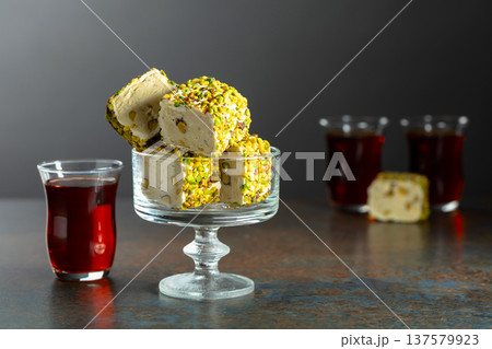 Turkish delights with black tea on a dark  background. 137579923