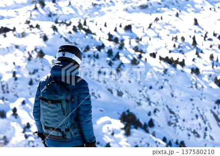 Male skier enjoying snowy mountain scenery Male skier enjoying snowy mountain scenery 137580210