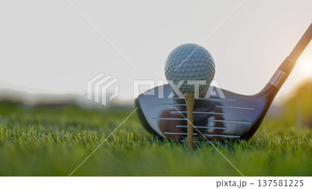 Golf clubs and balls on a green lawn in a beautiful golf course with morning sunshine. 137581225