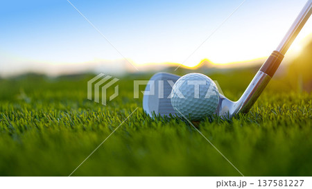 Golf clubs and balls on a green lawn in a beautiful golf course with morning sunshine. 137581227
