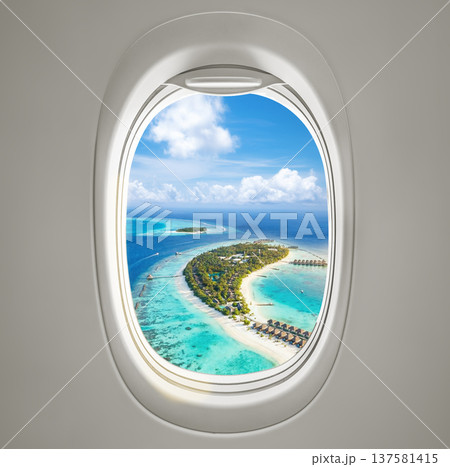 Aerial view of a tropical beach captured from an airplane porthole, showcasing a stunning perspective 137581415