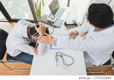 Top view of Doctor holding patient's hand for encouragement, empathy, cheering and support while medical examination. Bad news lessening, medicine and health care concept. 137582884