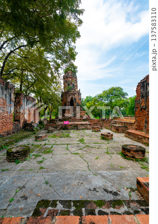 Ancient stupa towers in Ayutthaya historical park, Thailand. Ruins of former Siam capital under blue sky on sunny day. Famous travel destination with cultural heritage and Buddhist history. Ancient stupa towers in Ayutthaya historical park, Thailand. Ruins of former Siam capital under blue sky on sunny day. Famous travel destination with cultural heritage and Buddhist history. 137583110