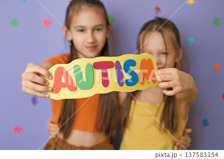 Happy, friendly children show the colorful inscription autism on the card. The doctrine of equality and tolerance and mutual assistance 137583154
