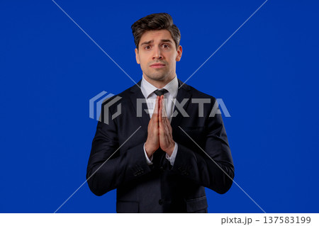 Businessman Praying With Palms Together In Sincere Silent Request. Hope, Faith Businessman Praying With Palms Together In Sincere Silent Request. Hope, Faith 137583199