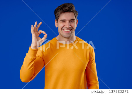 Positive Mature Man With Ok, Okay Hand Sign Gesture. Happy Man On Blue Studio 137583271