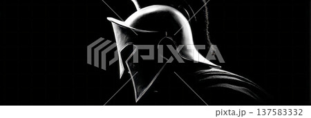 A spartan helmet is displayed in profile against a dark background. Light shines through the helmet creating a strong silhouette, highlighting ancient warrior history and Greek culture, banner 137583332