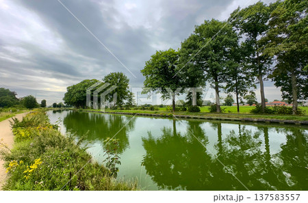Rijkevorsel, Antwerpse Kempen, Belgium, Overcast heavens cast muted light on quiet waterway scene 137583557