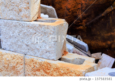 Construction work involves stone blocks stacked in building site with dirt Construction work involves stone blocks stacked in building site with dirt 137583581