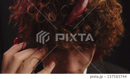 A red hot pepper in curly hair. Allegory. Abstraction 137583744