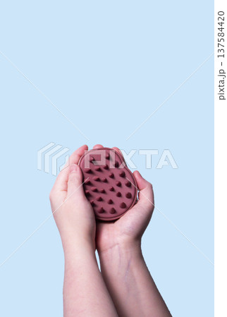 Pink hair brush for scalp massage against blue background. Mock up. Vertical Pink hair brush for scalp massage against blue background. Mock up. Vertical 137584420
