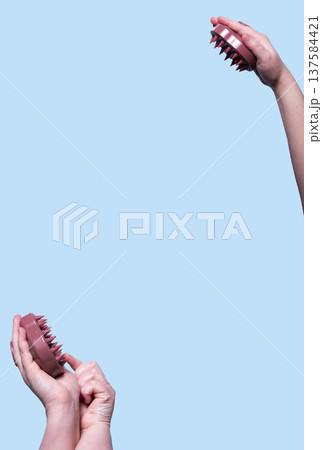 Pink hair brush for scalp massage against blue background. Mock up. Vertical Pink hair brush for scalp massage against blue background. Mock up. Vertical 137584421