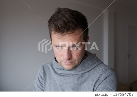 Mid Shot Emotional Portrait of a Middle Aged Man Looking Reproachfully at the Camera Mid Shot Emotional Portrait of a Middle Aged Man Looking Reproachfully at the Camera 137584708