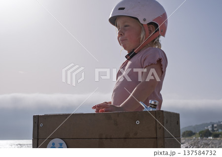 Little Girl Drinking Water from Public Fountain 137584732