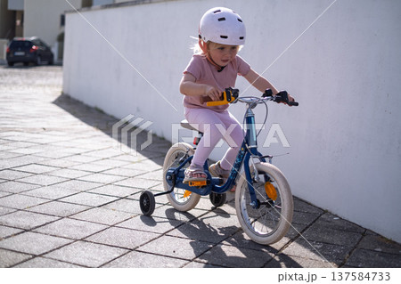 Little Girl Learning to Ride a Bicycle Little Girl Learning to Ride a Bicycle 137584733