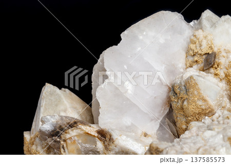 Macro mineral stone Snow quartz with calcite on a black background Macro mineral stone Snow quartz with calcite on a black background 137585573