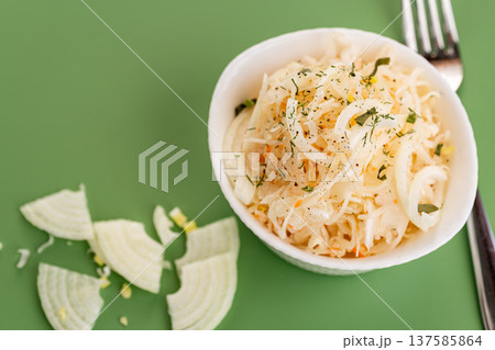fresh cabbage salad with onion in white bowl fresh cabbage salad with onion in white bowl 137585864