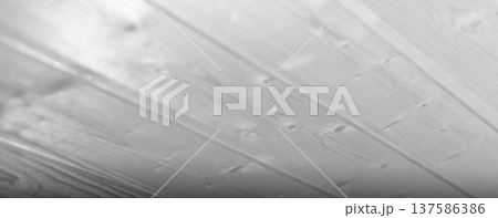 Close-up view of white wooden planks of ceiling, showcasing smooth glossy grains 137586386