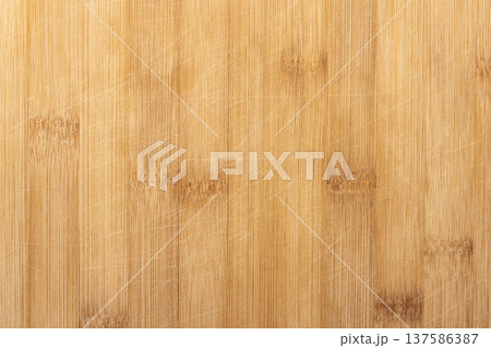 Background photo texture of a bamboo wood cutting desk with knife scratches Background photo texture of a bamboo wood cutting desk with knife scratches 137586387