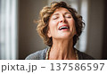 Joyful elderly woman singing with closed eyes, emotional portrait of mature woman enjoying music at home 137586597