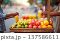 Fresh tropical fruit stall at a bustling street market, organic pomegranate, mango and citrus drinks 137586611