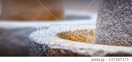 Traditional stone mill granite texture extreme macro circular shape rough surface ancient tool closeup kitchen equipment Thai culture rustic detail 137587173