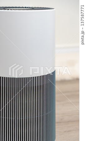 Modern air filter device with sleek design and vertical stripes, enhancing indoor air quality in contemporary living spaces Modern air filter device with sleek design and vertical stripes, enhancing indoor air quality in contemporary living spaces 137587771