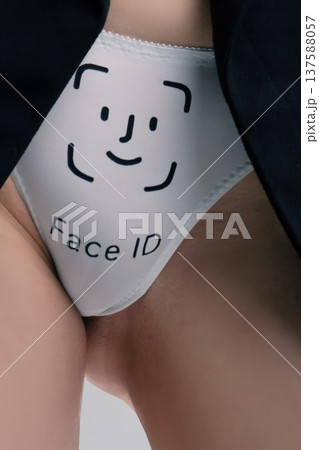Close up of underpants with a Face ID graphic and a smiling face, worn by a woman 137588057