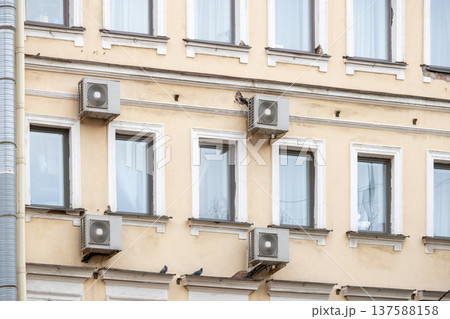 air conditioning on facade of building, air cooling in hot weather. air conditioning on facade of building, air cooling in hot weather. 137588158