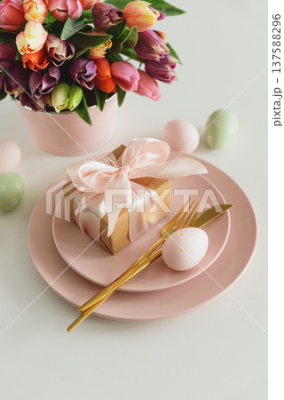 Easter Table Setting with Gift Box, Decorated Eggs and Tulips. Festive Spring Arrangement 137588296
