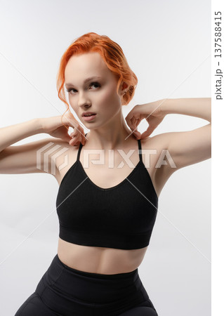 Elegant woman poses in artistic light projection with a confident expression 137588415