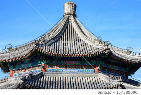 Traditional east asian temple roof against blue sky 137589000