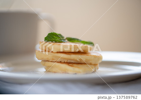 Stack of pancakes with mint leaves on white plate for breakfast Stack of pancakes with mint leaves on white plate for breakfast 137589762
