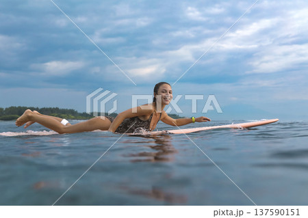 Smiling Young Lady Engaged In Peaceful Paddle As Sunrise Gently Lights Water Smiling Young Lady Engaged In Peaceful Paddle As Sunrise Gently Lights Water 137590151