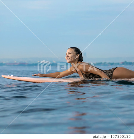 Energetic Woman With Bright Smile Engaged In Coastal Surfing Adventure Energetic Woman With Bright Smile Engaged In Coastal Surfing Adventure 137590156