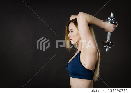 Fit woman doing exercise with dumbbells Fit woman doing exercise with dumbbells 137590772