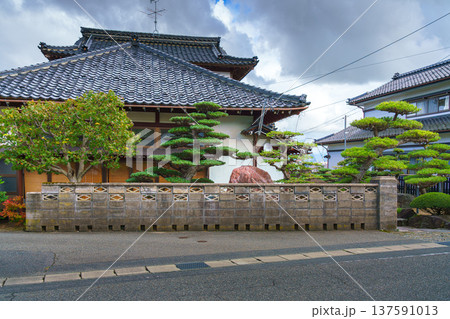 Sakata, Yamagata, Japan - Oct 5 2024, Panoramic view of a private house built in classic Japanese style with a tiled roof and a garden in front of facade behind a stone fence, Sakata, Japan Sakata, Yamagata, Japan - Oct 5 2024, Panoramic view of a private house built in classic Japanese style with a tiled roof and a garden in front of facade behind a stone fence, Sakata, Japan 137591013