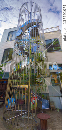 Sakata, Yamagata, japan - Oct 5 2024, A vertical view of a children's spiral slide enclosed by a fence at a kindergarten on the grounds of Jichi-in Temple, no people, Sakata, Japan 137591071