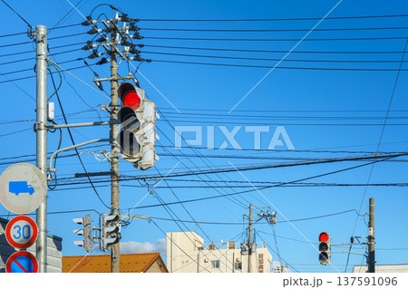 Sakata, Yamagata, japan - Oct 5 2024, Panoramic view of a traffic light with a red signal on against the background of power lines, poles, road signs and a clear blue sky, Sakata, Japan Sakata, Yamagata, japan - Oct 5 2024, Panoramic view of a traffic light with a red signal on against the background of power lines, poles, road signs and a clear blue sky, Sakata, Japan 137591096