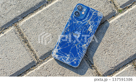 broken Apple iPhone lies on the sidewalk broken Apple iPhone lies on the sidewalk 137591386