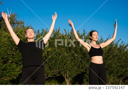Empowering moment of connection in nature during yoga practice at sunrise Empowering moment of connection in nature during yoga practice at sunrise 137592147